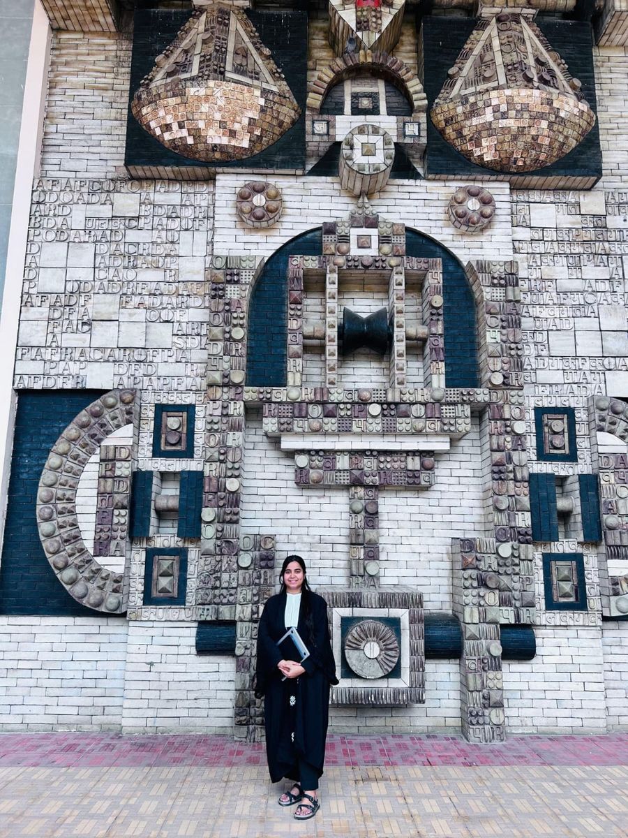 Himani Kalra, advocate in Delhi, standing in front of a patterned stone wall